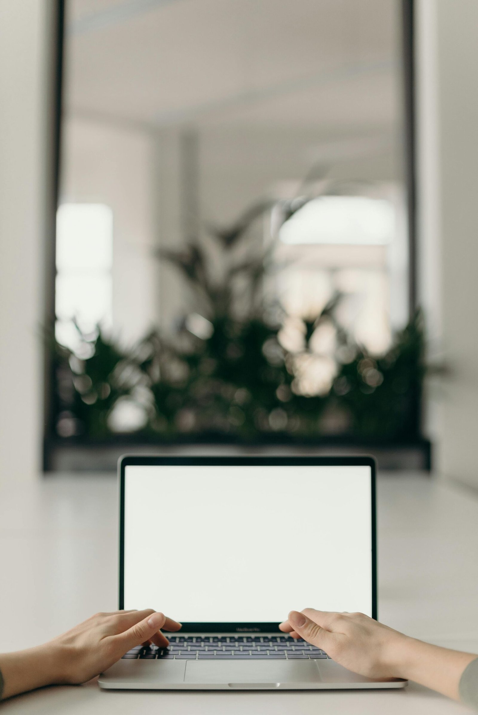 pexels-photo-4065617-4065617 A minimalist workspace featuring an open laptop in a bright, serene indoor setting.